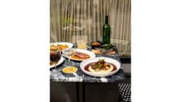 An elegant dinner spread with a bottle of wine
