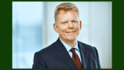 Guido Kerkhoff, Chairman of the Executive Board of thyssenkrupp in dark suit with red tie, in article about third-quarter loss in Industrial Services division.