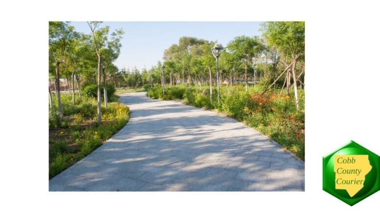 A sidewalk curving among trees