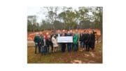 Group photo of people from non-profits with a giant display check